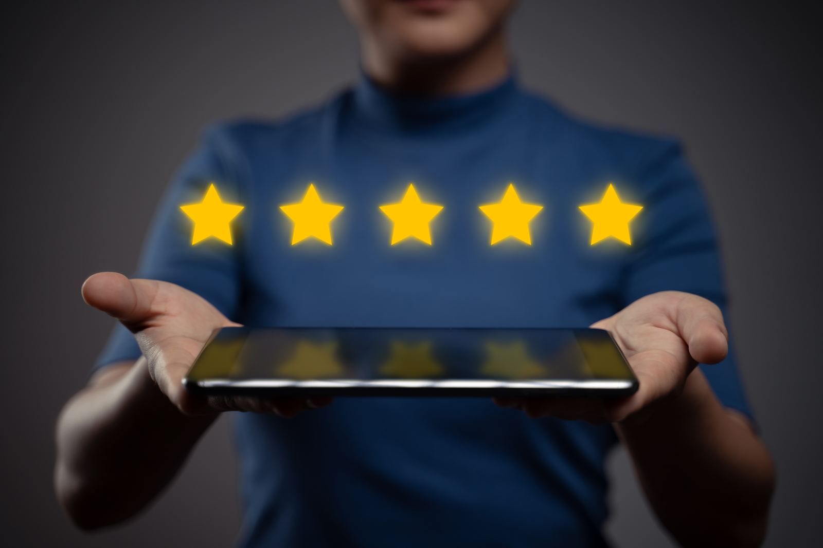 Woman showing tablet present feedback, reviews with five stars icon hologram effect
