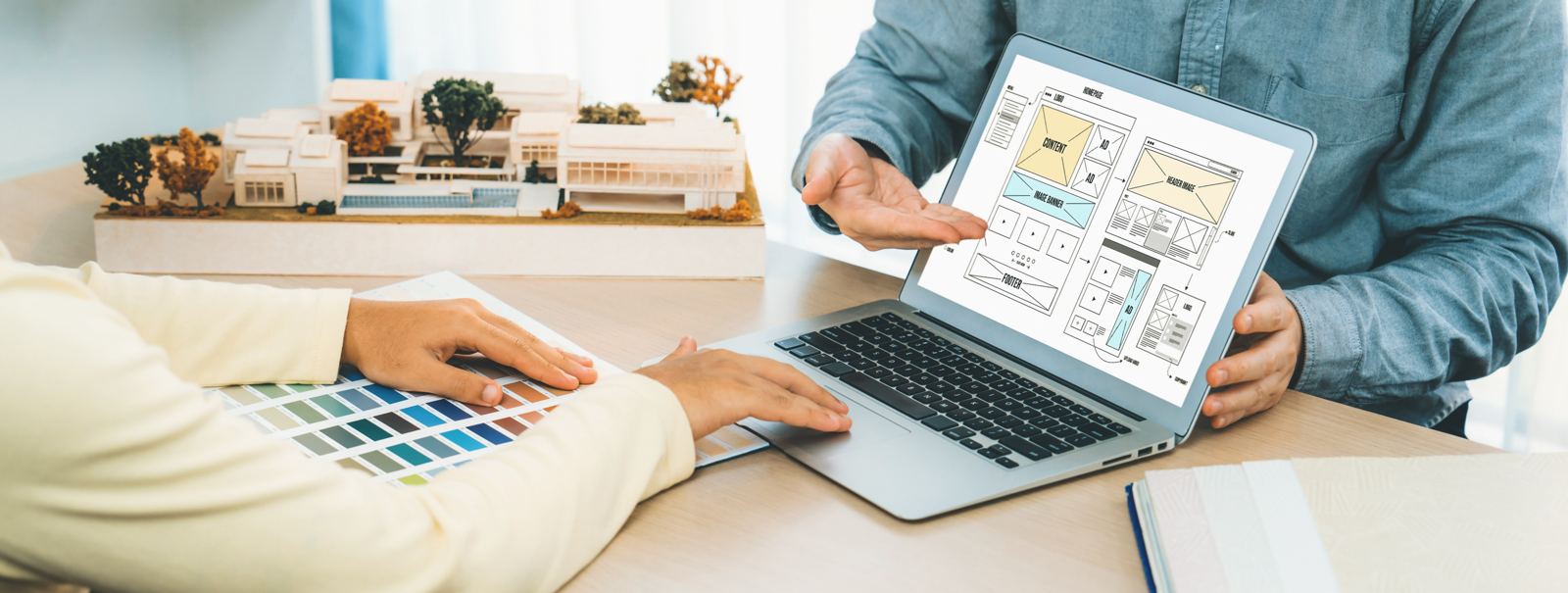 Designer presents color while laptop displayed website designs Variegated